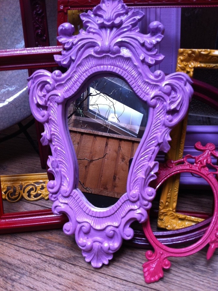 Purple mirror with an irregular shape and ornate border