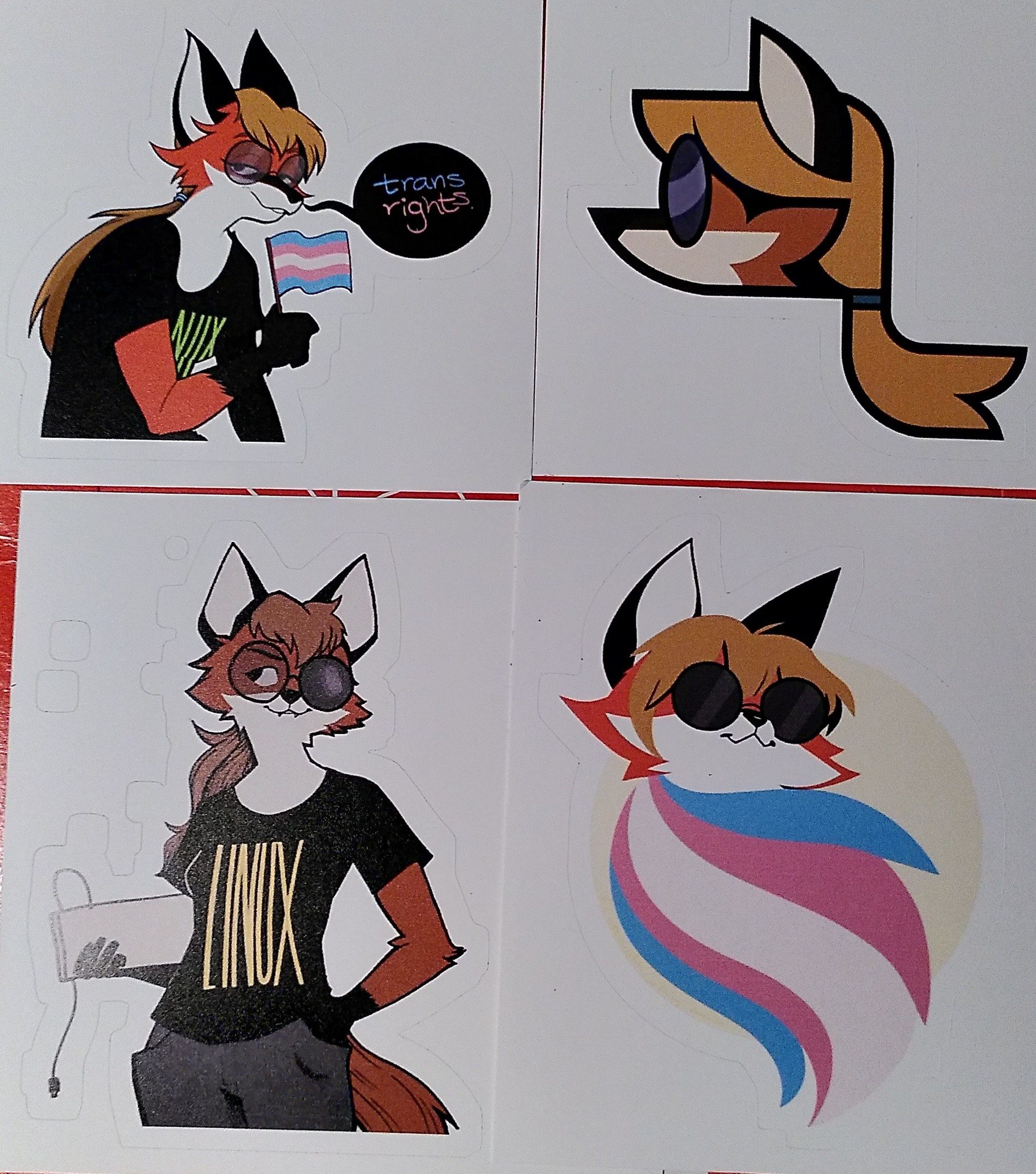 4 stickers of xenia, the linux mascot. Two say trans right.