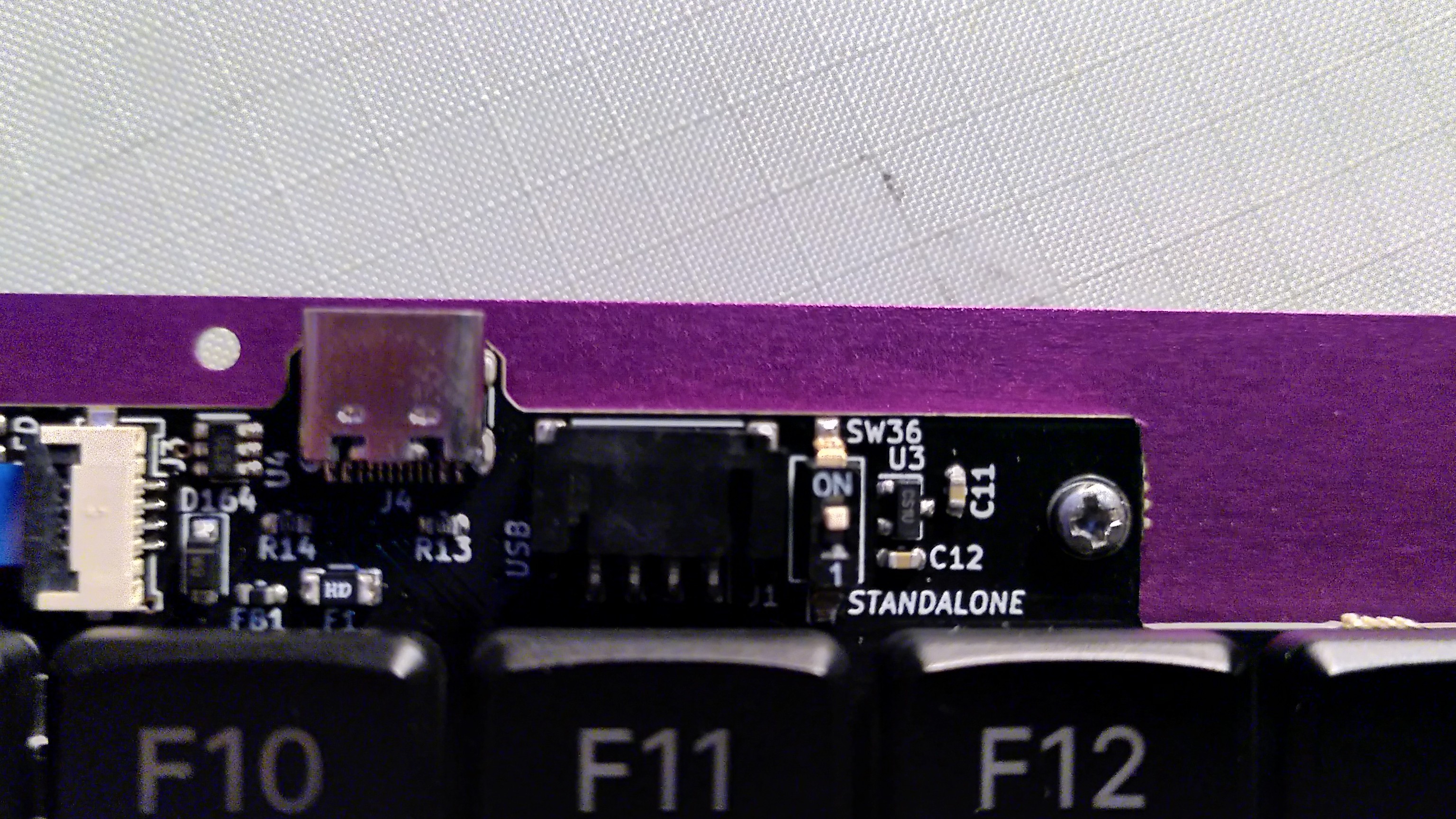 Close up on the pcb of the mnt reform keyboard with the dip switch choosing if the keyboard is meant to be used as part of a laptop or standalone