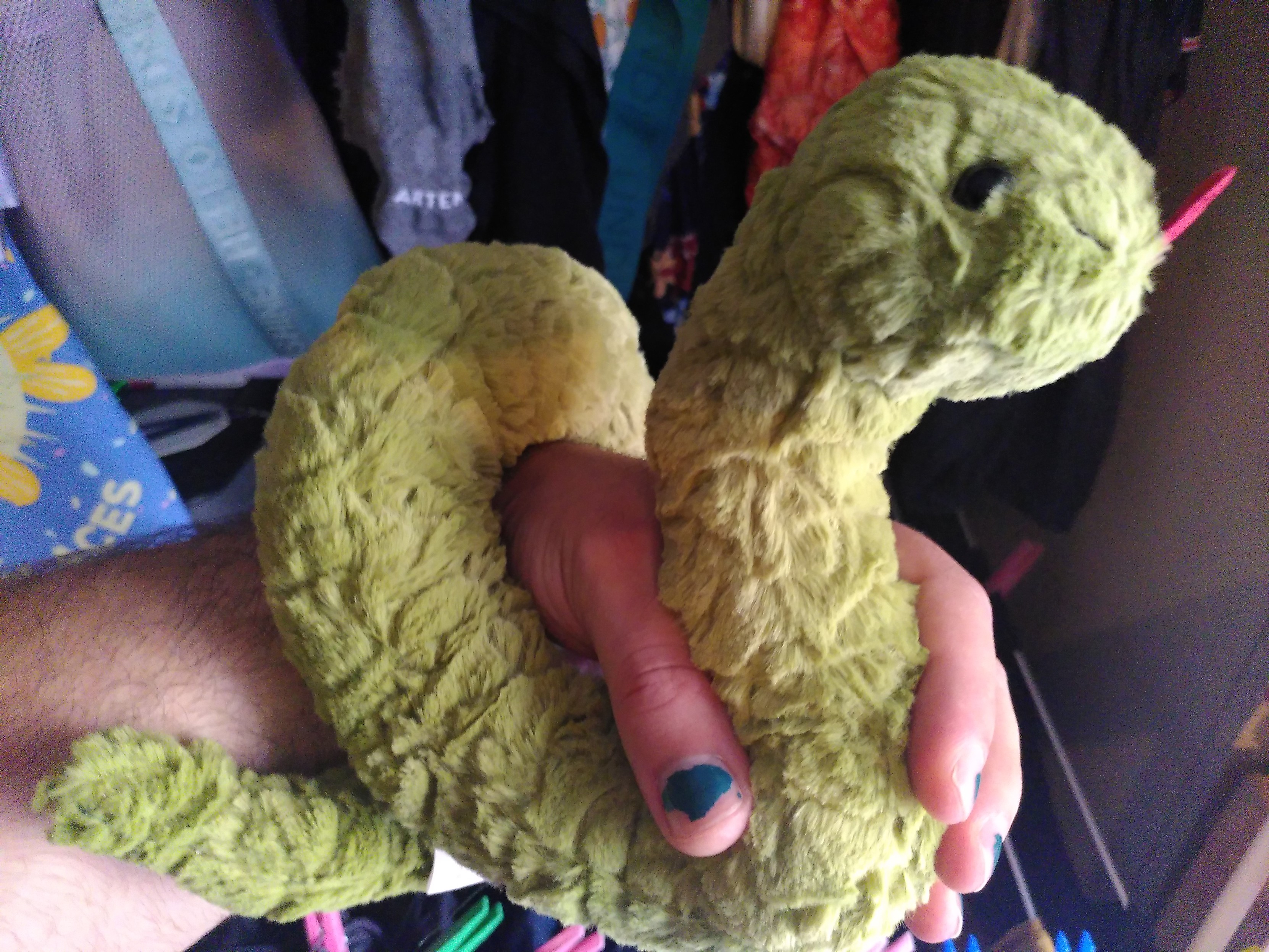 A python plushie wrapping around my fore arm