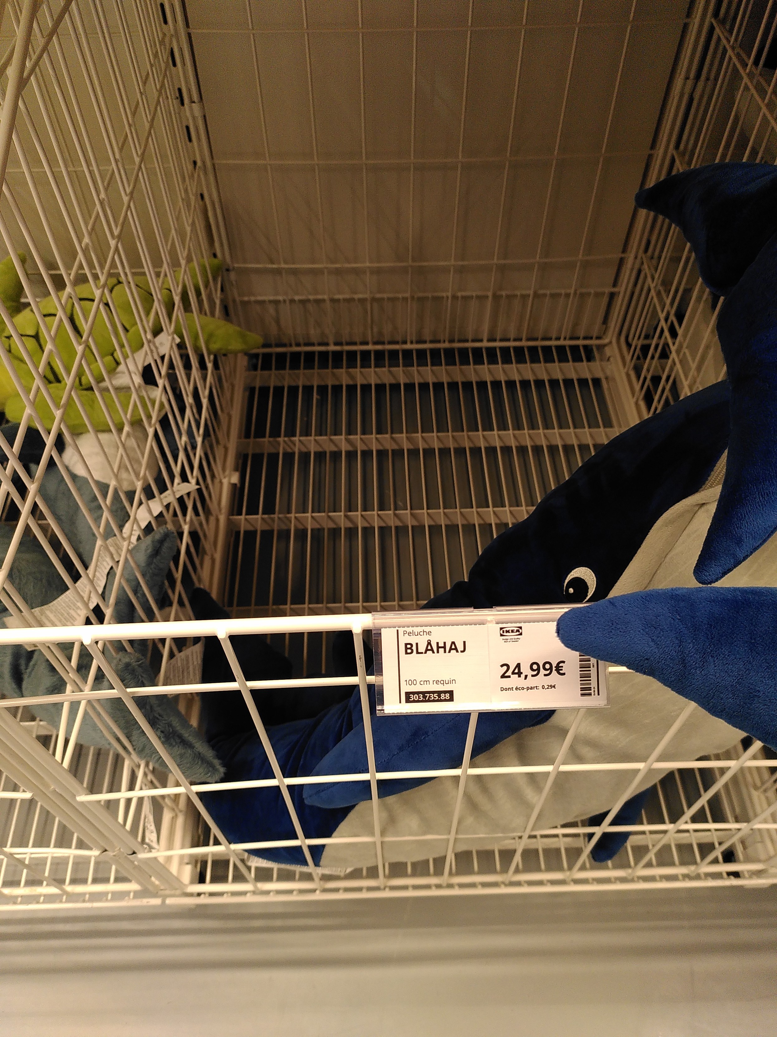 A box with a blahaj label empty of any shark