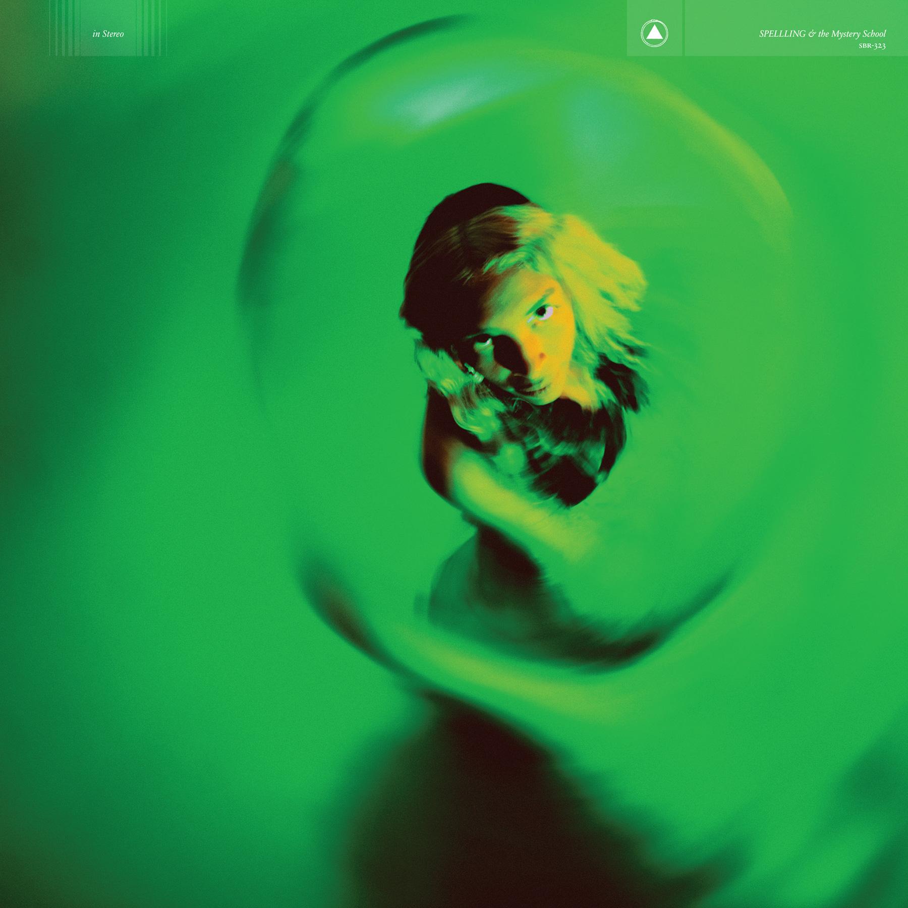 SPELLLING & the Mystery School by SPELLLING

Cover is mainly green with a black woman looking toward the camera nearly above her. She is under a green light