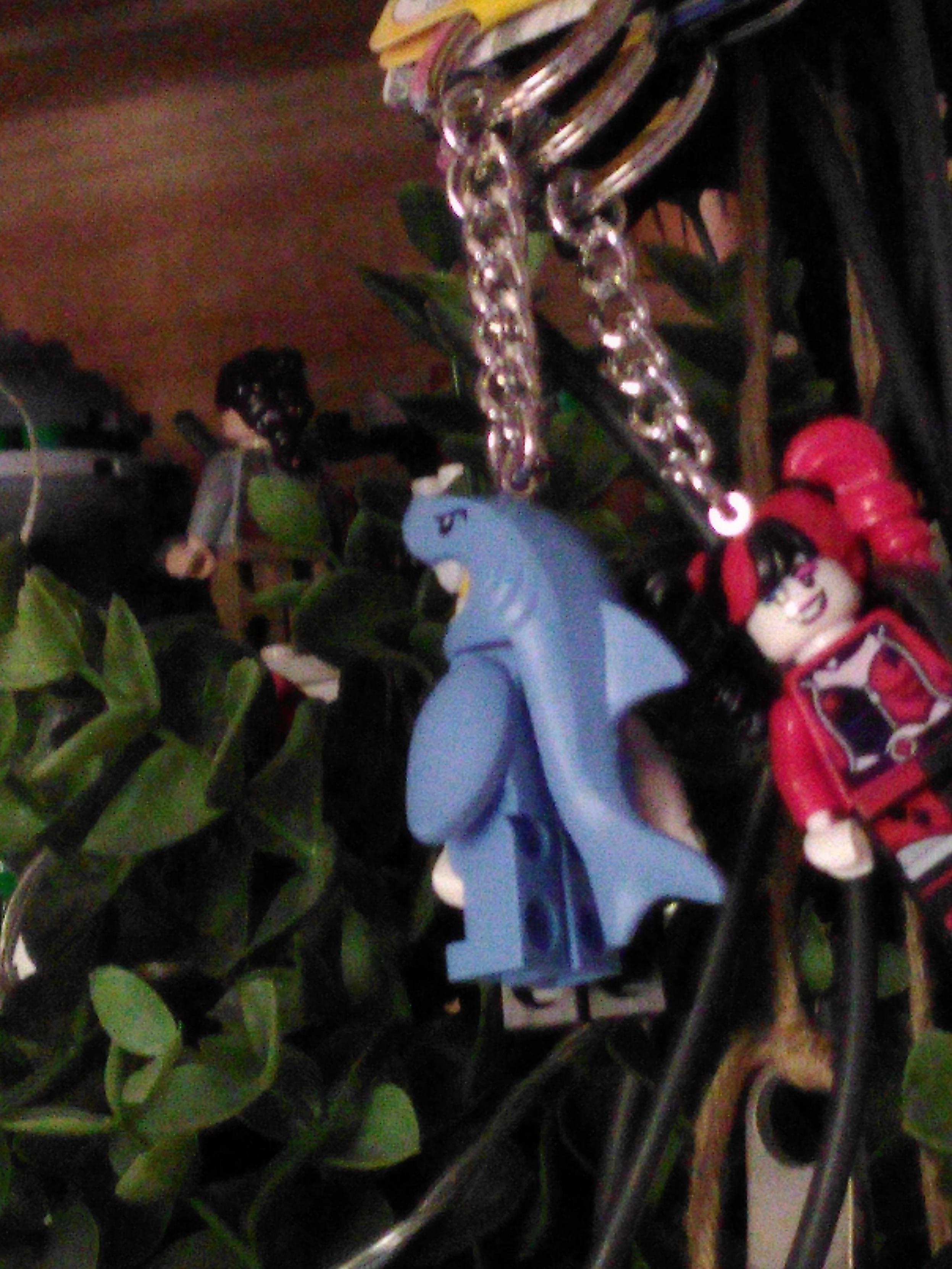 Two lego keyring, one of a figurine in a shark costume and one of harley queen