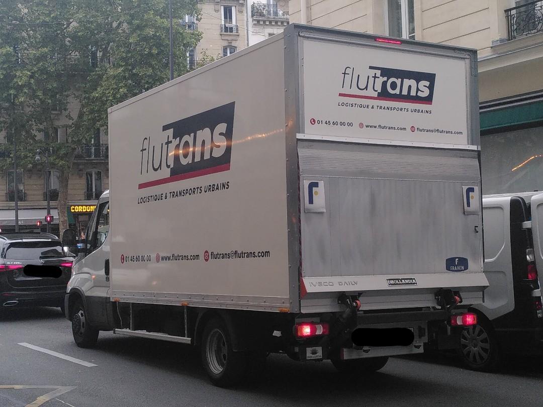 A truck with written on the side flutrans in big and a caption 