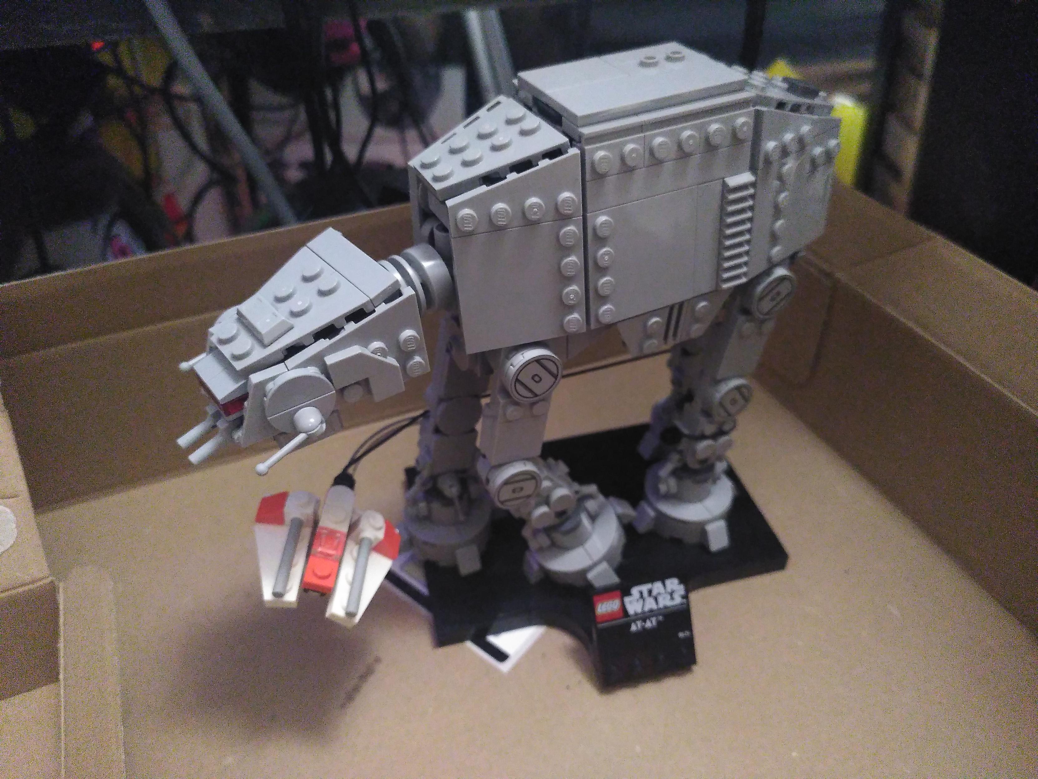 Photo of a lego AT-AT with a snowspeeder circling its legs